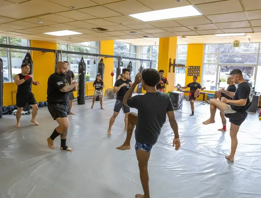 Group Muay Thai class drilling knee strikes together